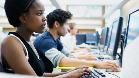 Getty Images A stock image of US university students in exams. There are a row of students in front of computers