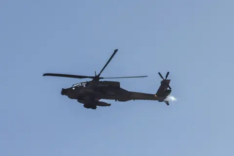 Getty Images This picture taken from a position in northern Israel, on the border with southern Lebanon, shows an Israeli Air Force AH-64 Apache helicopter flying on 4 June 2026.