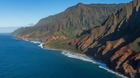 Getty Images At the end of th the Kalalau Trail is Kalalau Beach, below spear-like rock formations called the Cathedral Spires in the Na Pali Cliffs in the Na Pali Coast State Park on Kauai, Hawaii.