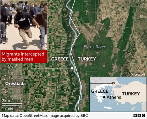  A satellite map of the border between Greece and Turkey along the Evros River. The river runs vertically through the centre, with “GREECE” labelled on the left and “TURKEY” on the right. Agricultural fields and a town labelled Orestiada appear on the Greek side. A white line traces part of the border. In the top-left corner, there is an inset photo of a masked man infront of a crowd of people. A red caption over this inset reads “Migrants intercepted by masked men” At the bottom right, a small inset map shows the location of the area within Greece, with Athens marked. A scale indicating distance (2 km / 1 mile) appears at the bottom left.