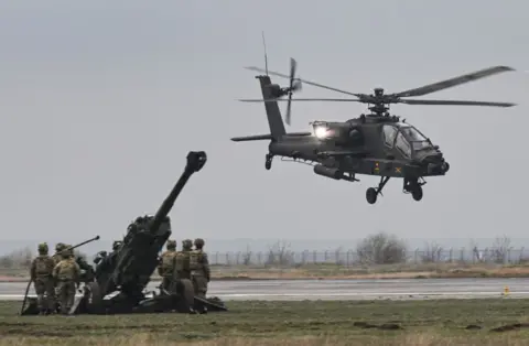 Getty Images An Apache helicopter takes off during a demonstration on a military base