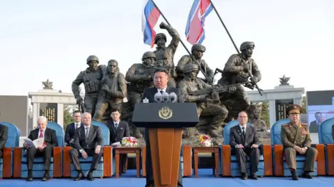 Reuters via KCNA Kim Jong Un speaks during the opening ceremony of a memorial for North Korean troops killed while fighting for Russia in the war against Ukraine