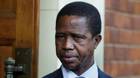 Getty Images A head and shoulders image of Edgar Lungu. His blue collar and dark jacket can just be seen at the bottom of the picture. 