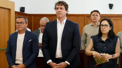 EPA Miguel Angel Gallardo, former leader of the Extremadura branch of the ruling party PSOE; David Sanchez, brother of Spanish Prime Minister Pedro Sanchez, and Elisa Moriano Morales, former director of the Culture Area, attend the start of their trial at the provincial court of Badajoz, Spain, 28 May 2026. David Sanchez, Gallardo, and nine others are on trial for corruption and abuse of power regarding Sanchez's 2017 hiring as a regional music coordinator.