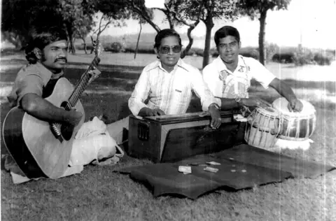 Stills Ravi Ilaiyaraaja is in the middle. Left is his brother Gangai Amaran, Music Director and on his right is elder brother Bhaskar, a tabla player in the team.