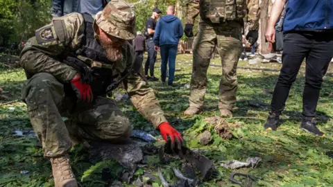 UA:PBC"/Global Images Ukraine A military expert examines a bomb's fragments collected at the site of a Russian aerial bombing in the Shevchenkivskyi district on May 5, 2024 in Kharkiv, Ukraine