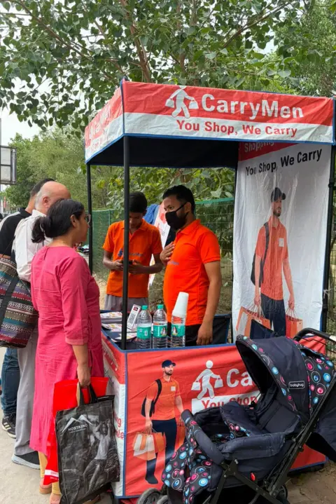Geeta Pandey/BBC The Sabharwals at the CarryMen kiosk