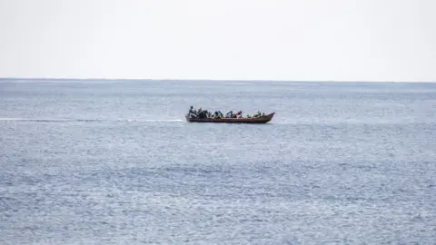 Getty Images People on a boat as it moves through water