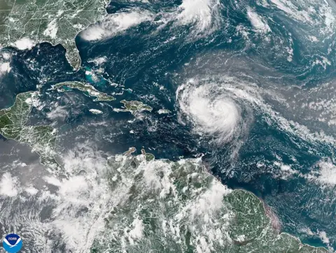 Getty Images A satellite image shows Hurricane Erin advancing in the Atlantic Ocean