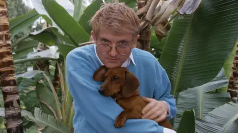 Getty Images Hockney pictured with one of his beloved dachshunds in 1988