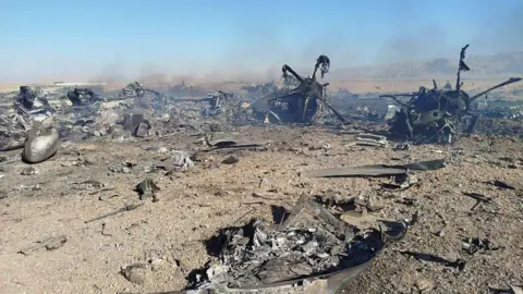 Getty Images Wreckage is seen from what Iranian authorities say is a US military helicopter that crashed during a mission to rescue the missing American pilot of an F-15E that was downed earlier this week, in a handout image provided on April 5, 2026 in an unspecified location in Iran.