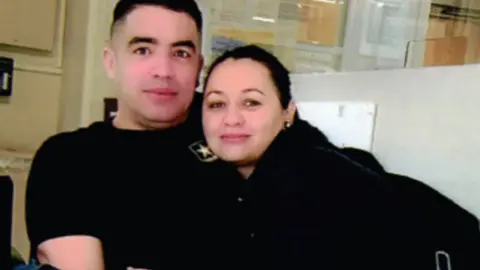 Courtesy of attorney Matthew Kozik A man and a woman, both wearing black, embrace and look towards the camera