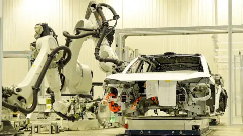 A car being assembled with robots inside the Nio factory in Hefei