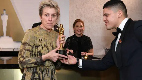 Getty Images US actress Frances McDormand attends the 90th Academy Awards Governors Ball where she holds up a golden Oscar statuette being handed to her in 2018. 