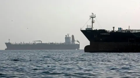 Getty Images Two ships seen in the Strait of Hormuz.