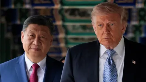 Reuters Xi and Trump walk under a decorated ceiling
