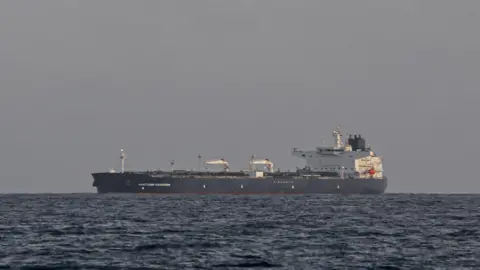 Getty Images The Anatoly Kolodkin oil tanker, a black and white large vessel, is seen in the ocean from the port of Matanzas