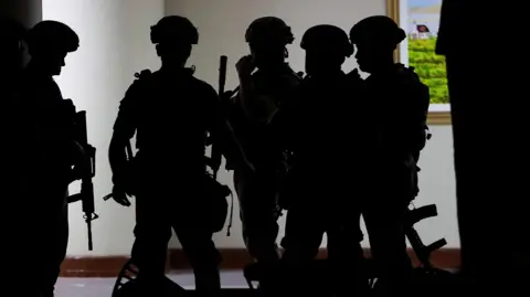 Reuters Military personnel in camouflage fatigues enter the Senate building where Philippine Senator Ronald "Bato" dela Rosa, the chief enforcer of former president Rodrigo Duterte's drug war, at the Senate, is under protective custody amid an International Criminal Court warrant, as more than a dozen gunshots were heard at the Philippine Senate on Wednesday, and people were told to run for cover, according to a Reuters witness, in Pasay City, Metro Manila, Philippines, May 13, 2026. REUTERS/Eloisa Lopez
