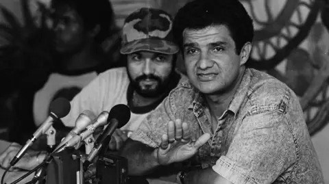 Reuters MIskito Indian rebel leader Brooklyn Rivera (R) makes a point during a press conference in Managua while fellow leader Stedman Fagoth looks on. He said the talks have stalled due to the intransigence of the Sandinistas. May 16, 1988