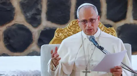 Reuters Pope Leo speaks at a podium.