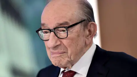 Getty Images Alan Greenspan is photographed in later life. He is looking off to the side and not smiling.
