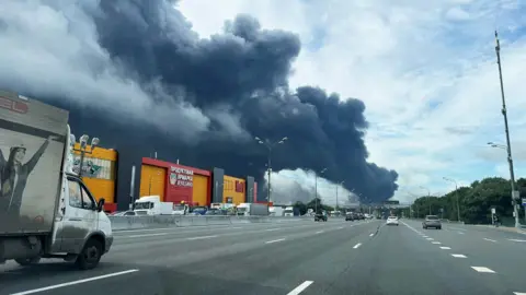 Reuters Black smoke billows over the Moscow ringroad from a fire at a Moscow oil refinery