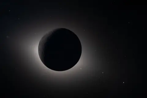 NASA A dark circle in th eblackness of space with the Sun's atmosphere shimmering around its edges.