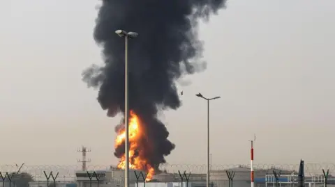 EPA Smoke rises from an area near Dubai International Airport (DXB) in Dubai, United Arab Emirates, 16 March