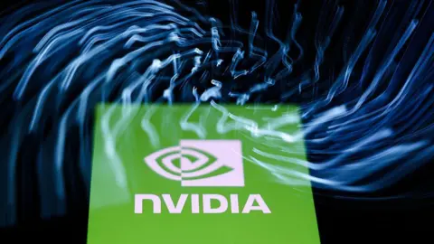 NurPhoto via Getty Images A laptop keyboard and Nvidia logo displayed on a phone screen are seen in this multiple exposure illustration photo 