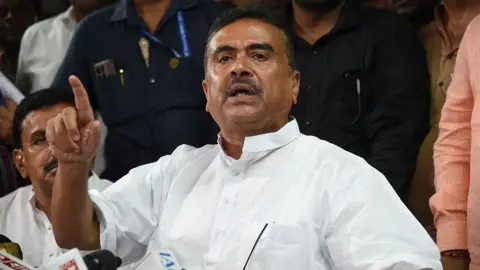Getty Images Suvendu Adhikari, a leader of the Bharatiya Janata Party and winning candidate from Bhawanipur and Nandigram assembly constituencies, seen speaking to the media in Kolkata. He is wearing a collarless white shirt.