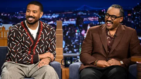 Getty Images Actor Michael B. Jordan & filmmaker Ryan Coogler during an interview on Wednesday, 2 April, 2025. Jordan is wearing a patterned brown cardigan, Coogler is wearing a brown checked jacket.