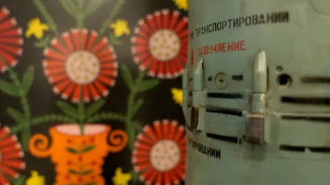 BBC/Moose Campbell Artwork is seen inside the drone command centre next to bits of artillery and missile cases