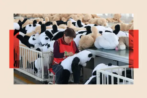 VCG via Getty Images A woman in a factory sews cuddly toy pandas
