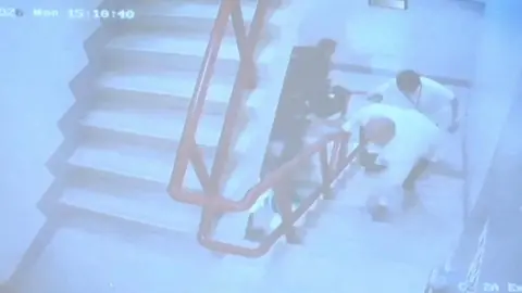 Reuters Philippine Senator Ronald dela Rosa stumbles on stairs as he runs away from Philippine law enforcement agents inside the Philippine Senate.