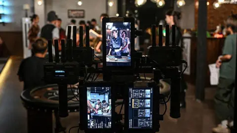 AFP via Getty Images The photo taken on October 10, 2025 shows the monitor screens at a micro-drama film studio in Shanghai