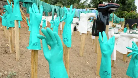 AFP via Getty Images A view of gloves and boots used by medical staff, drying in the sun, at a centre for victims of the Ebola virus in Guekedou, on April 1, 2014.