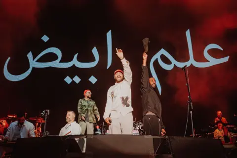 Luke Dyson Bashy and Kano on stage with Gorillaz