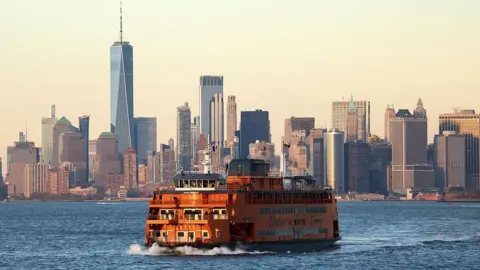 Getty Images The popular Staten Island Ferry is pictured with New York City in the backdrop