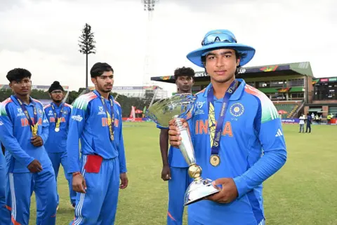 ICC via Getty Images HARARE, ZIMBABWE - FEBRUARY 06: Vaibhav Suryavanshi of India poses with the ICC U19 Men´s Cricket World Cup Trophy after winning the ICC U19 Men´s Cricket World Cup 2026 following the ICC U19 Men's Cricket World Cup 2026 Final between England and India at Harare Sports Club on February 06, 2026 in Harare, Zimbabwe. 
