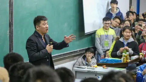 stringer/ Feature China/Future Publishing via Getty Images Students listen to a lecture by education influencer Zhang Xuefeng visiting Henan University of Technology in Zhengzhou in central China's Henan province