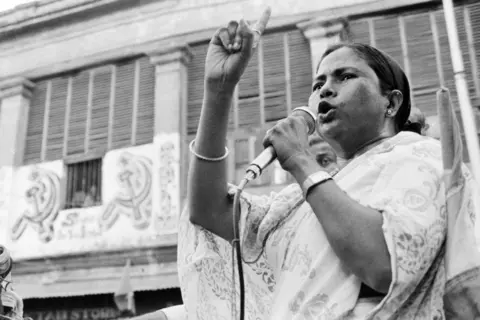 Sondeep Shankar/Getty Images Congress leader Mamata Banerjee, with folded hands, rides in an open jeep during the election campaign in the South Kolkata constituency of West Bengal on May 7, 1991. (Photo by Sondeep Shankar/Getty Images)