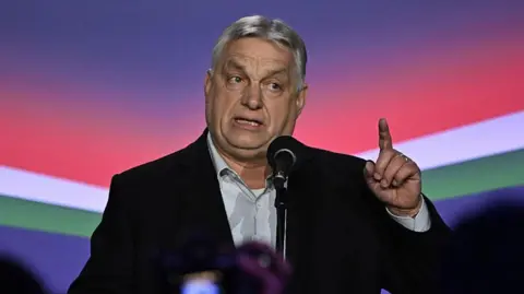 AFP via Getty Images File picture of Viktor Orban speaking to journalists