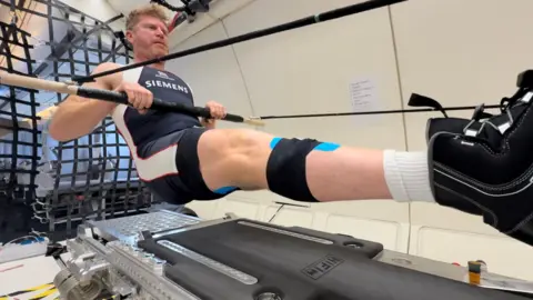 John Kennett Matthew Wells, olympic medalist, floats as he rows on a parabolic flight.