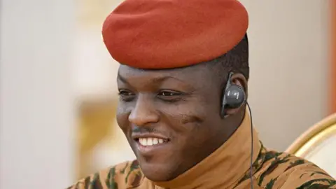 Anadolu via Getty Images Burkina Faso President Ibrahim Traoré in a red beret and military uniform