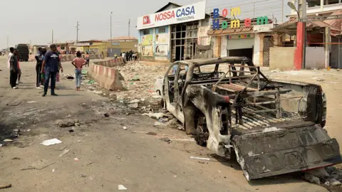 Getty Images Burnt truck on the street of Luanda.