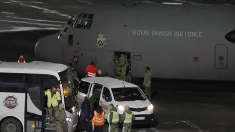 Reuters A Danish air force transport plane and military personnel are seen in Greenland's capital Nuuk. Photo: 14 January 2026