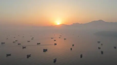 Reuters many vessels anchored as the sun rises in the Gulf
