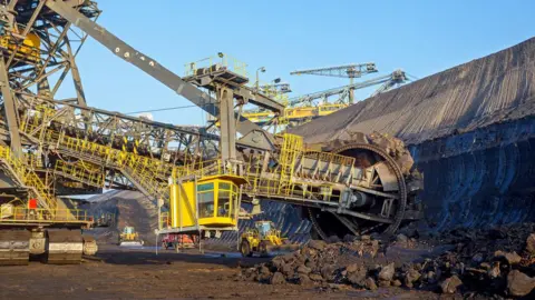 AFP via Getty Images Mining machines at an open-cast lignite coal mine in eastern Germany