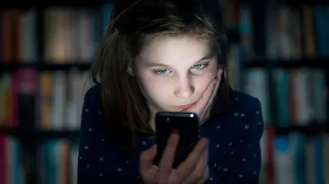 Getty Images A girl looking at a phone