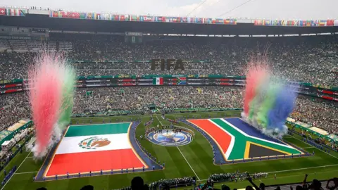 AFP via Getty Images This view shows the Mexican and South African flags during the opening ceremony ahead of the 2026 World Cup Group A football match between Mexico and South Africa at the Mexico City Stadium in Mexico City